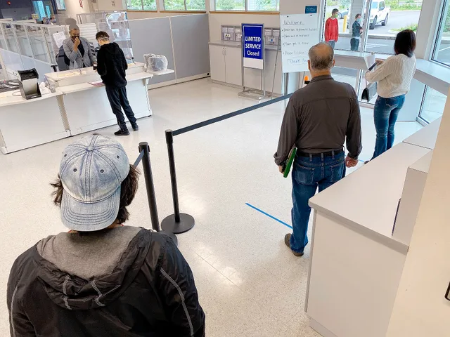 Customers stand six feet apart as they wait to check in for scheduled appointments. Separating a frequent annoyance from a serious rare failure
